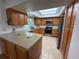 Bright kitchen featuring wood cabinets, stainless steel appliances, and a large countertop with tiled floors at 11708 Nicklaus Cir, Tampa, FL 33624