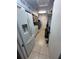 Functional laundry room with appliances, shelving, and convenient storage solutions at 11708 Nicklaus Cir, Tampa, FL 33624