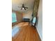 Cozy living room with hardwood floors, a stone fireplace, and a comfortable seating area at 11708 Nicklaus Cir, Tampa, FL 33624