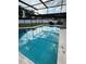 Refreshing screened-in pool featuring a clear blue hue and ample space for outdoor relaxation and entertainment at 11708 Nicklaus Cir, Tampa, FL 33624