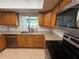 Kitchen sink beneath a window with stainless steel appliances and tile backsplash at 11708 Nicklaus Cir, Tampa, FL 33624