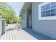 A large balcony overlooking a parking lot and neighboring trees in a tranquil and relaxing setting at 11868 Skylake Pl # 11767, Temple Terrace, FL 33617