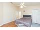 This bedroom features wood-look floors, neutral walls, and a ceiling fan at 11868 Skylake Pl # 11767, Temple Terrace, FL 33617