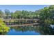 Picturesque view of a wooden bridge reflected on calm waters, surrounded by lush greenery at 11868 Skylake Pl # 11767, Temple Terrace, FL 33617