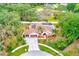 Beautiful aerial view of home featuring a large lot, private pool, solar panels, and a circular driveway at 12302 Knight Pl, Thonotosassa, FL 33592