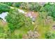 A high definition aerial view of a home featuring solar panels and a screened-in pool at 12302 Knight Pl, Thonotosassa, FL 33592