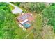 A high definition aerial view of a home showcasing the solar panels and screened-in pool at 12302 Knight Pl, Thonotosassa, FL 33592