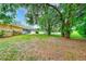 Expansive backyard featuring a pool enclosure and mature trees, providing ample privacy at 12302 Knight Pl, Thonotosassa, FL 33592