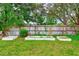 The well-kept backyard features garden beds and a wooden fence, enhancing the outdoor space at 12302 Knight Pl, Thonotosassa, FL 33592
