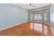 Bedroom with hardwood floors, bay windows overlooking the pool, and a ceiling fan at 12302 Knight Pl, Thonotosassa, FL 33592