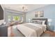 Serene primary bedroom with bay windows, plush bedding, and a calming color palette at 12302 Knight Pl, Thonotosassa, FL 33592