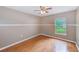 Bedroom showcasing wood floors, a window, and neutral colored walls at 12302 Knight Pl, Thonotosassa, FL 33592