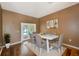 Formal dining area with hardwood floors, neutral walls, white table and backyard views at 12302 Knight Pl, Thonotosassa, FL 33592