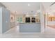 Bright kitchen features a breakfast bar, modern appliances, and light wood cabinets at 12302 Knight Pl, Thonotosassa, FL 33592