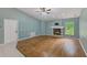 Bright living room with fireplace, hardwood floors, and ample natural light at 12302 Knight Pl, Thonotosassa, FL 33592