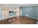Open-concept living room boasts wood floors, light-filled spaces, and seamless flow into the kitchen at 12302 Knight Pl, Thonotosassa, FL 33592