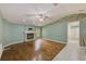 Spacious living room featuring a stone fireplace, neutral wall color, and hardwood flooring at 12302 Knight Pl, Thonotosassa, FL 33592