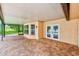 Covered patio features brick flooring and pool access through the french doors at 12302 Knight Pl, Thonotosassa, FL 33592