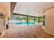 Backyard pool with screen enclosure and brick patio at 12302 Knight Pl, Thonotosassa, FL 33592