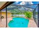 A lovely pool with a screen enclosure and paver patio at 12302 Knight Pl, Thonotosassa, FL 33592