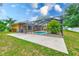 Screened in pool with an open deck area surrounded by lush green grass at 12302 Knight Pl, Thonotosassa, FL 33592