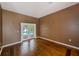 A room with hardwood floors and French doors offering a glimpse of the inviting backyard pool at 12302 Knight Pl, Thonotosassa, FL 33592