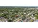 Residential property with mature trees, well-maintained lawns, and a quiet neighborhood street at 1411 Barry St, Clearwater, FL 33756
