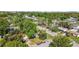 A cozy home featuring a well-manicured lawn and lush trees in a quiet neighborhood setting at 1411 Barry St, Clearwater, FL 33756