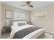 Bedroom with a ceiling fan, two windows and carpet flooring at 1411 Barry St, Clearwater, FL 33756
