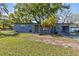Charming single-story home with a well-maintained lawn, palm trees, and a inviting front entrance at 1411 Barry St, Clearwater, FL 33756