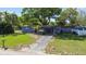 Cozy single-story home with a well-kept lawn and a spacious driveway, presenting classic curb appeal at 1411 Barry St, Clearwater, FL 33756