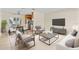 Staged living and dining area with tile floors, contemporary furnishings and stainless steel kitchen appliances at 1411 Barry St, Clearwater, FL 33756
