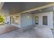 Spacious covered patio with decorative tile flooring and access to side entrance at 1411 Barry St, Clearwater, FL 33756