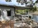Backyard featuring a canal view with a concrete patio and partial view of the home's exterior at 14616 Coral Dr, Hudson, FL 34667