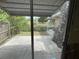 Backyard patio with stone wall and mature trees, providing privacy and outdoor relaxation space at 14616 Coral Dr, Hudson, FL 34667