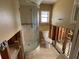 Bathroom featuring a glass shower and standard toilet amidst renovation with exposed framing at 14616 Coral Dr, Hudson, FL 34667