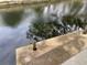 Waterfront view of a concrete dock extending into a canal with calm, reflective water at 14616 Coral Dr, Hudson, FL 34667