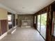 Open living area featuring a stone fireplace, offering a unique architectural element and access to the patio at 14616 Coral Dr, Hudson, FL 34667