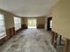 Open living room with sliding glass doors and large windows, providing plenty of light, ready for renovation at 14616 Coral Dr, Hudson, FL 34667
