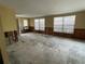 Bright living room with large windows, offering ample natural light and a blank canvas for your personal touch at 14616 Coral Dr, Hudson, FL 34667