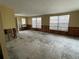 Bright living room with large windows, offering ample natural light and a blank canvas for your personal touch at 14616 Coral Dr, Hudson, FL 34667