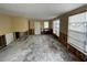 Spacious living room needing renovation, featuring large windows and original flooring, awaiting restoration at 14616 Coral Dr, Hudson, FL 34667