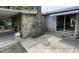 Spacious outdoor patio featuring stone accents, a rock chimney, and a covered area, perfect for entertaining at 14616 Coral Dr, Hudson, FL 34667