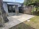 Outdoor patio with rock detail home, fenced yard, and tree at 14616 Coral Dr, Hudson, FL 34667