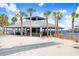 Beachside pavilion with shade, picnic tables and ocean views amid palm trees, perfect for relaxing or enjoying the waterfront at 14616 Coral Dr, Hudson, FL 34667