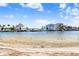 Beautiful waterfront view of luxurious homes along the canal with a sandy beach in the foreground at 14616 Coral Dr, Hudson, FL 34667