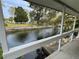 Scenic waterfront view from a covered patio, showcasing the tranquil canal and mature trees at 14616 Coral Dr, Hudson, FL 34667