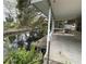 Waterfront property featuring a canal view and concrete stairs down to the water, amidst lush greenery at 14616 Coral Dr, Hudson, FL 34667
