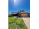 Welcoming brick home with a well-maintained lawn, attached garage, and long driveway at 1850 Oklahoma Ne Ave, St Petersburg, FL 33703