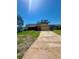 Brick home with an attached garage, spacious driveway, and green front lawn at 1850 Oklahoma Ne Ave, St Petersburg, FL 33703